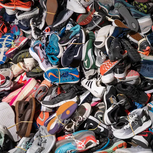 pile of sneakers in landfill